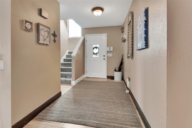 foyer entrance featuring a textured ceiling