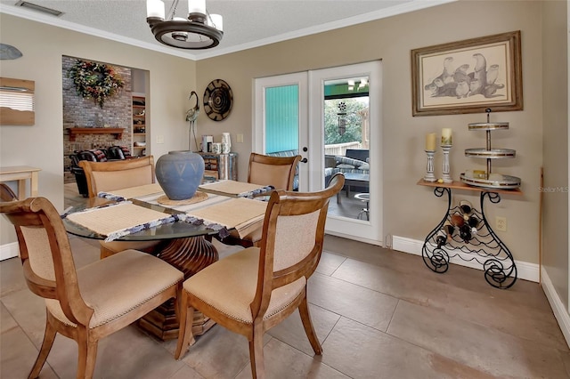 tiled dining space with a fireplace, french doors, a textured ceiling, and ornamental molding