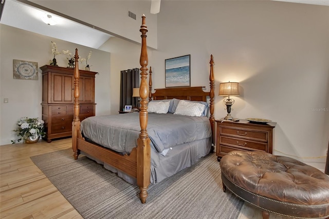 bedroom with lofted ceiling and light hardwood / wood-style flooring