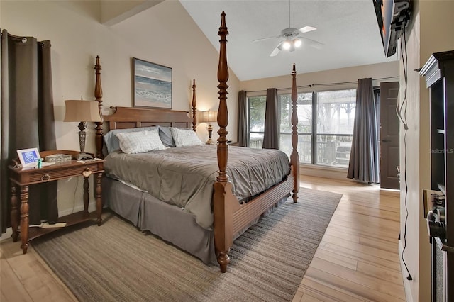 bedroom with light hardwood / wood-style floors, vaulted ceiling, and ceiling fan