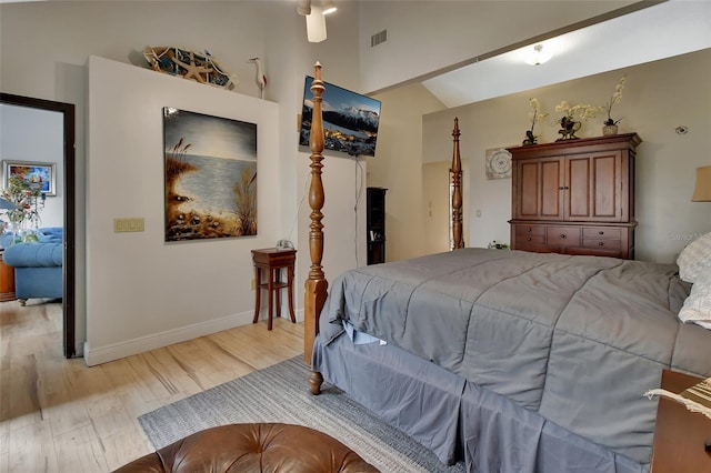 bedroom featuring lofted ceiling and light hardwood / wood-style flooring