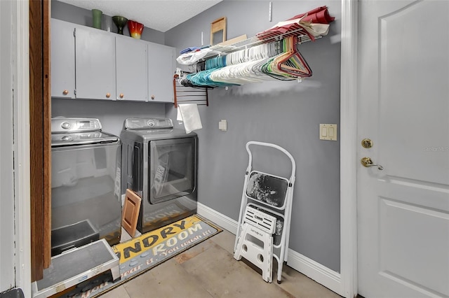 laundry room with cabinets and washing machine and dryer