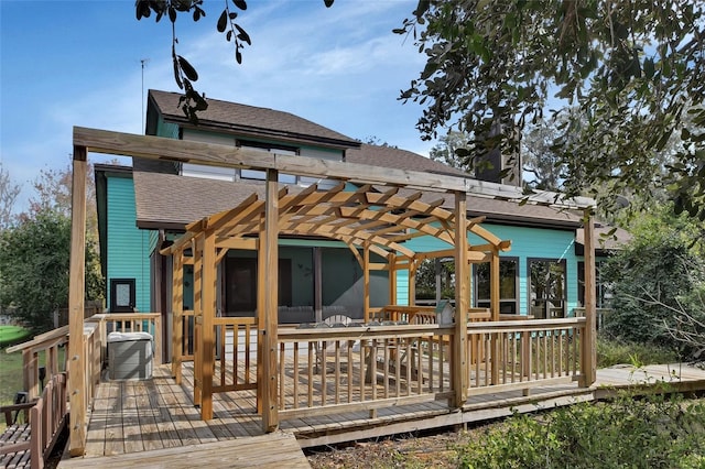 rear view of house with a pergola, a deck, and central AC unit