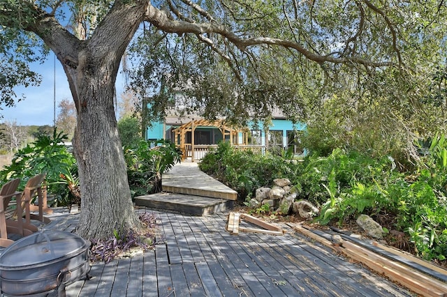 wooden terrace featuring a fire pit