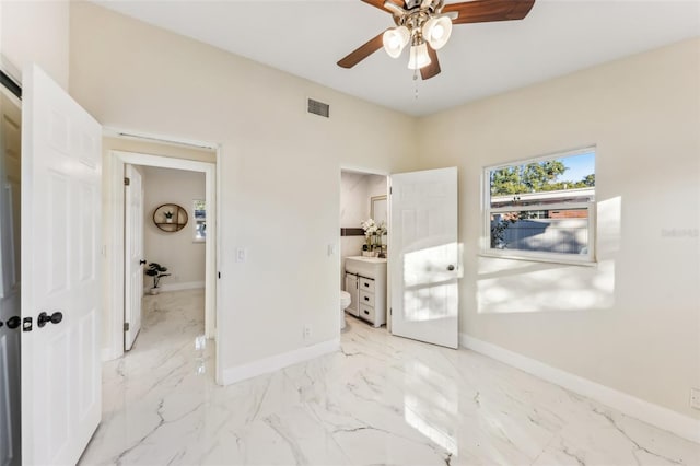 bedroom featuring ensuite bath and ceiling fan