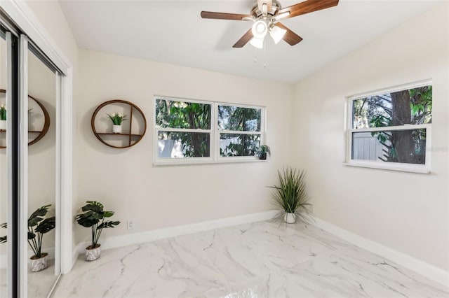 unfurnished room featuring a wealth of natural light and ceiling fan