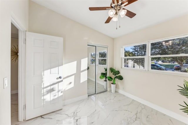 interior space with ceiling fan, vaulted ceiling, and a closet