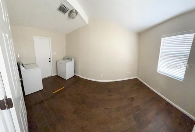 interior space with dark hardwood / wood-style flooring and washer / dryer