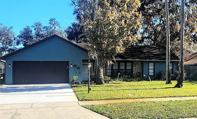 single story home with a garage and a front lawn