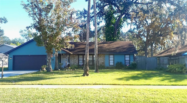 ranch-style home featuring a garage and a front lawn