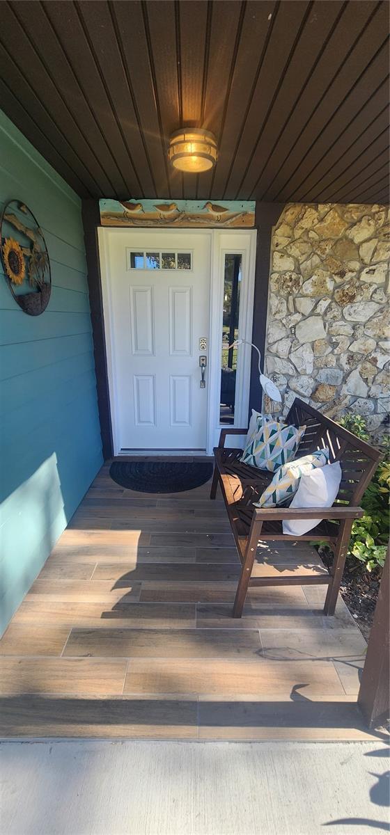 view of exterior entry with covered porch