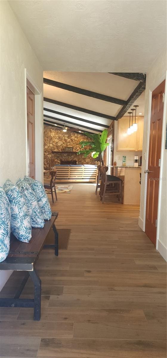 hall featuring dark hardwood / wood-style flooring and lofted ceiling with beams