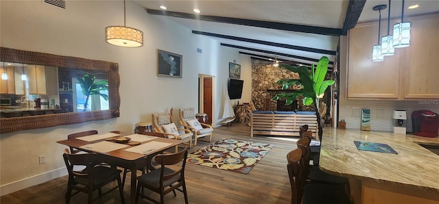 dining area featuring lofted ceiling with beams and dark hardwood / wood-style floors