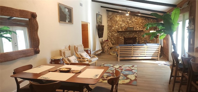 interior space with ceiling fan, lofted ceiling with beams, and wood-type flooring