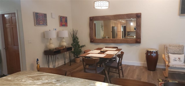 dining area with wood-type flooring