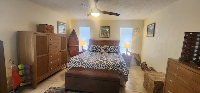 tiled bedroom featuring ceiling fan and a textured ceiling