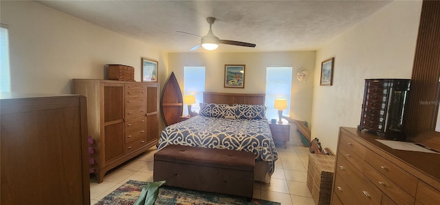 tiled bedroom featuring ceiling fan, wooden walls, and a textured ceiling