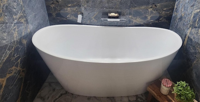 bathroom featuring a tub and tile walls