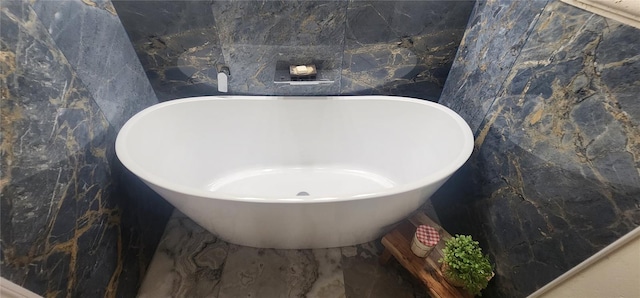 bathroom with tile walls and a tub