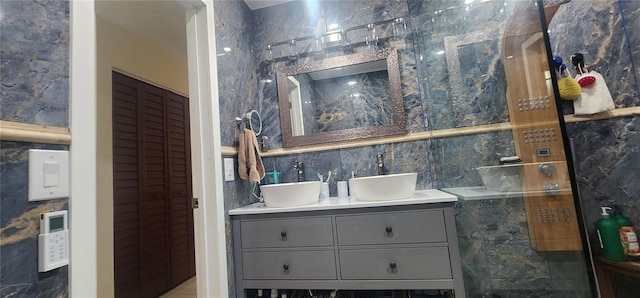 bathroom with vanity, backsplash, and tile walls