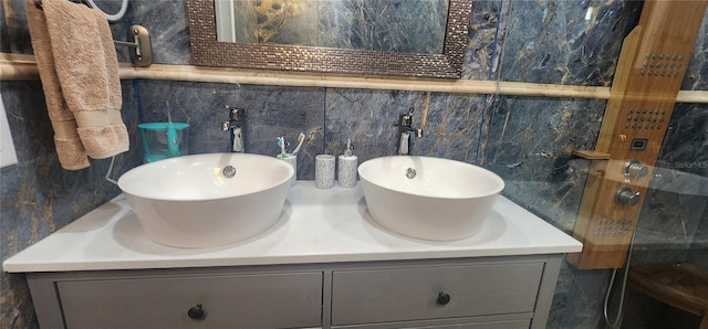 bathroom with vanity, tile walls, and tasteful backsplash