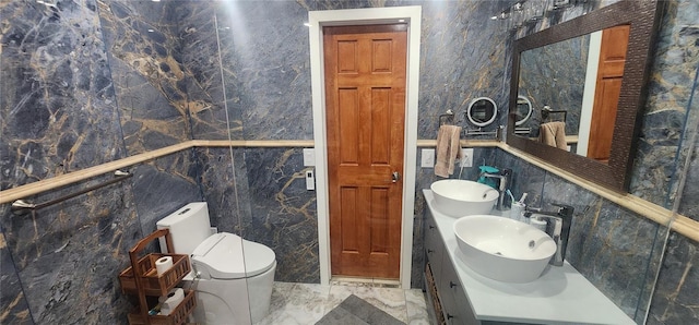 bathroom with toilet, sink, and tile walls