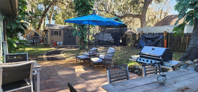 view of patio featuring a shed and grilling area