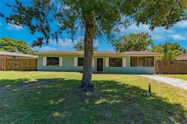 ranch-style home with a front lawn