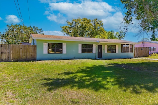 ranch-style home featuring a front yard