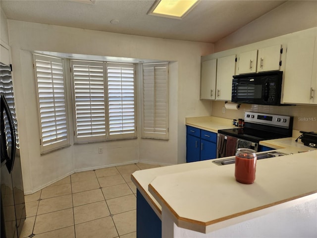 kitchen with kitchen peninsula, blue cabinets, light tile patterned floors, white cabinetry, and stainless steel electric range