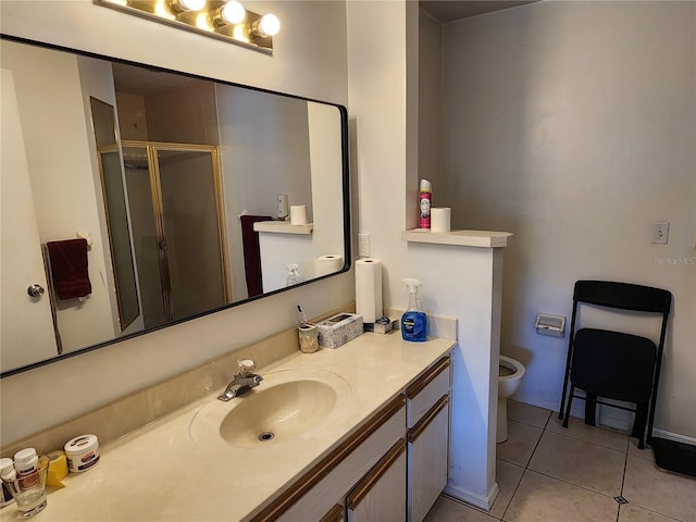 bathroom featuring tile patterned flooring, vanity, and walk in shower