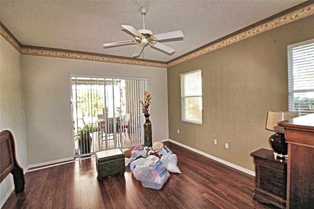 sitting room with ceiling fan, plenty of natural light, wood-type flooring, and ornamental molding