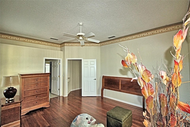 bedroom with a textured ceiling, dark hardwood / wood-style flooring, and ceiling fan