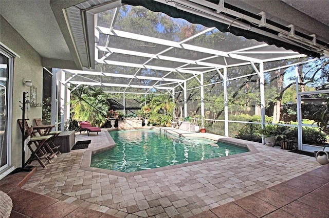 view of swimming pool featuring a lanai and a patio area