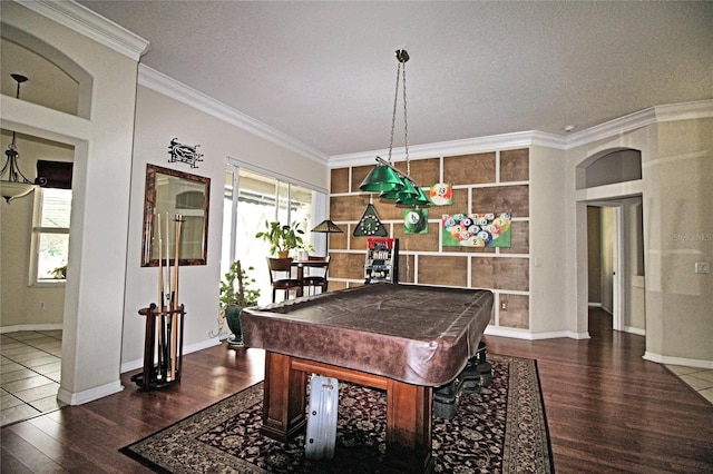 playroom featuring dark hardwood / wood-style flooring, crown molding, and pool table