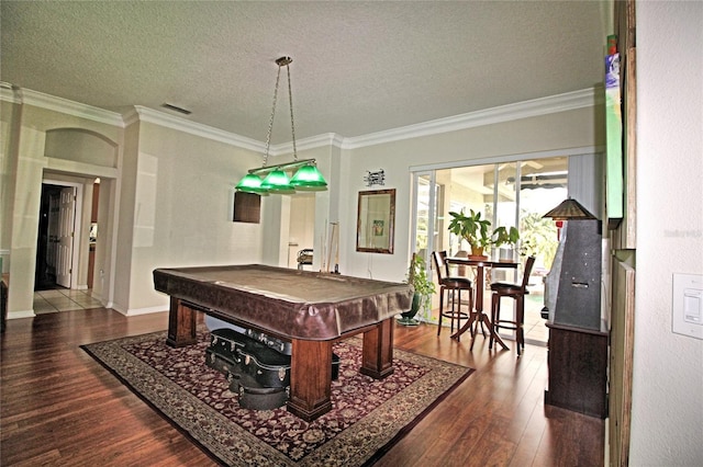 recreation room featuring dark hardwood / wood-style flooring, ornamental molding, a textured ceiling, and billiards