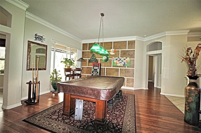 recreation room featuring crown molding, dark hardwood / wood-style flooring, a textured ceiling, and billiards