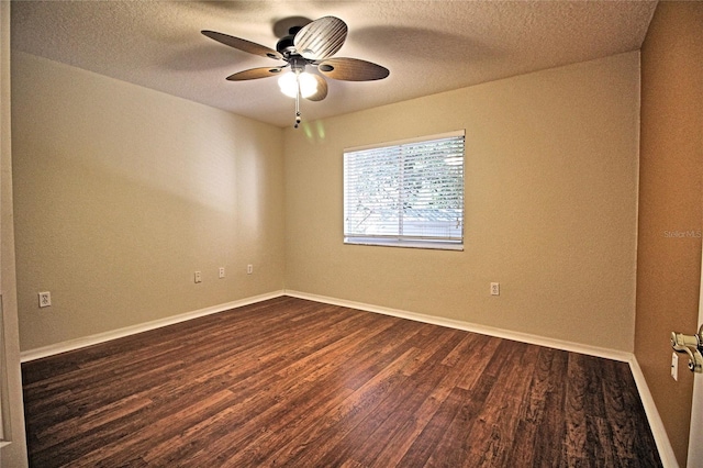 spare room with a textured ceiling, ceiling fan, and dark hardwood / wood-style floors