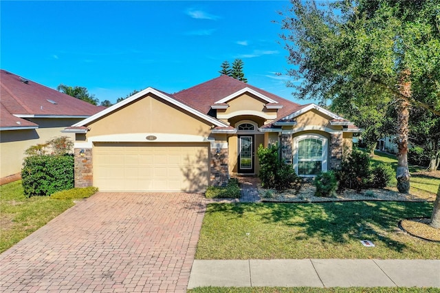 ranch-style house featuring a garage and a front yard