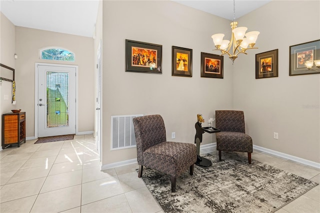 sitting room with light tile patterned floors and a chandelier