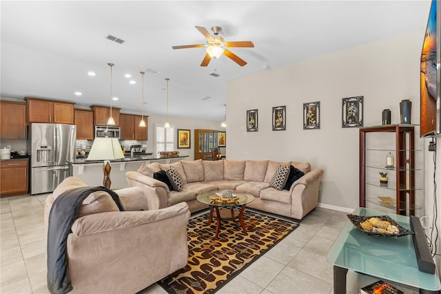 living room featuring ceiling fan and light tile patterned flooring