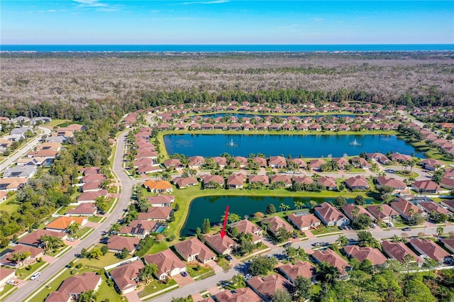 birds eye view of property with a water view