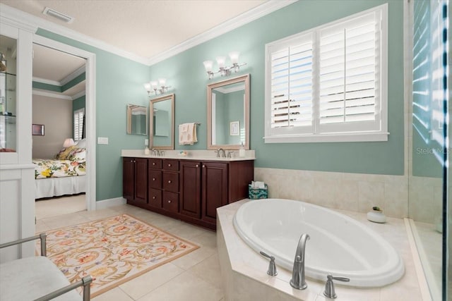 bathroom featuring tile patterned floors, crown molding, a relaxing tiled tub, and vanity