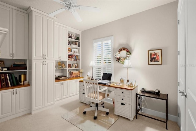 office area featuring ceiling fan and light carpet