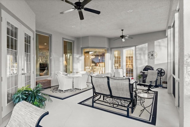 sunroom with ceiling fan and french doors