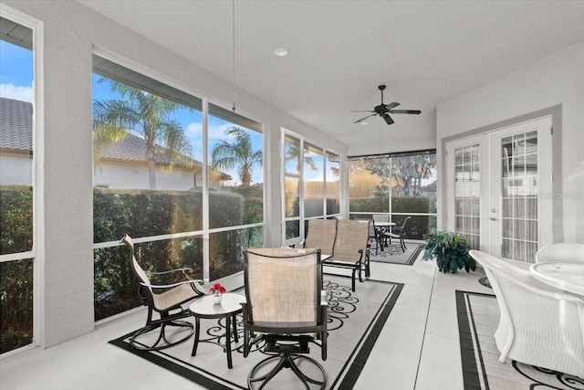 sunroom / solarium featuring a healthy amount of sunlight and ceiling fan