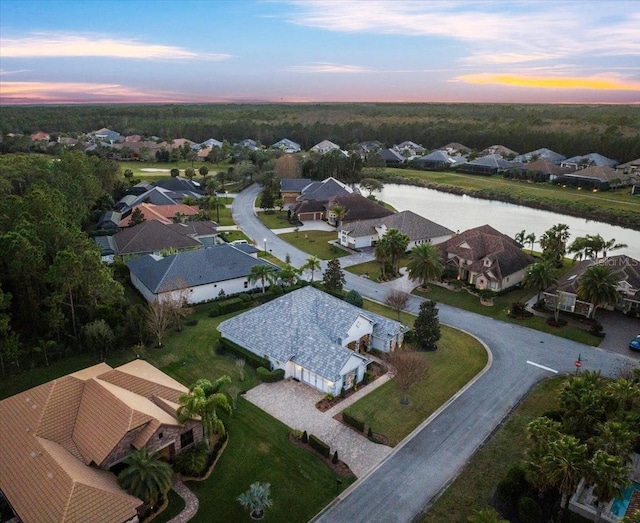 aerial view at dusk with a water view