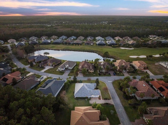 aerial view at dusk with a water view