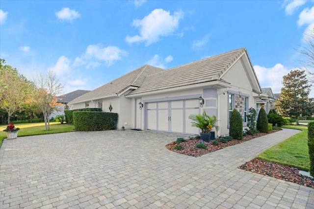 view of home's exterior featuring a garage and a lawn