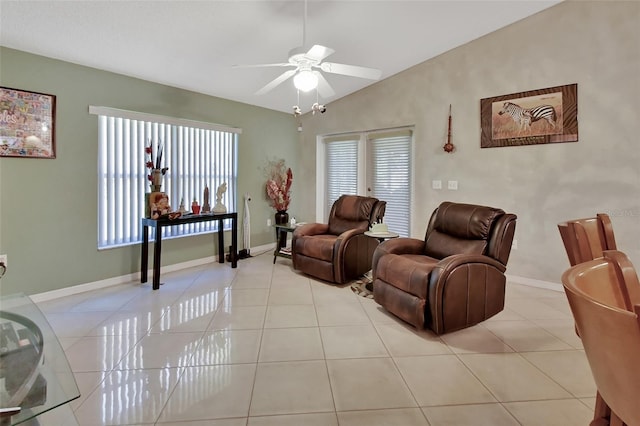 tiled living room featuring ceiling fan and vaulted ceiling